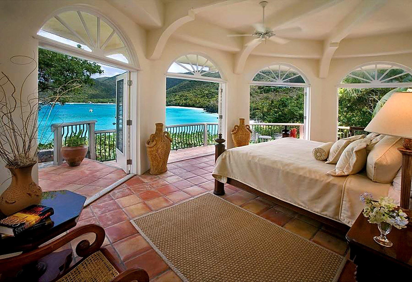 Villa bedroom with arched doors opening to the bay